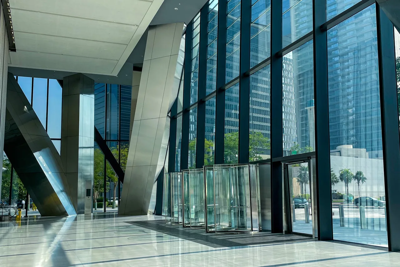 The glazed entrance of a modern office tower