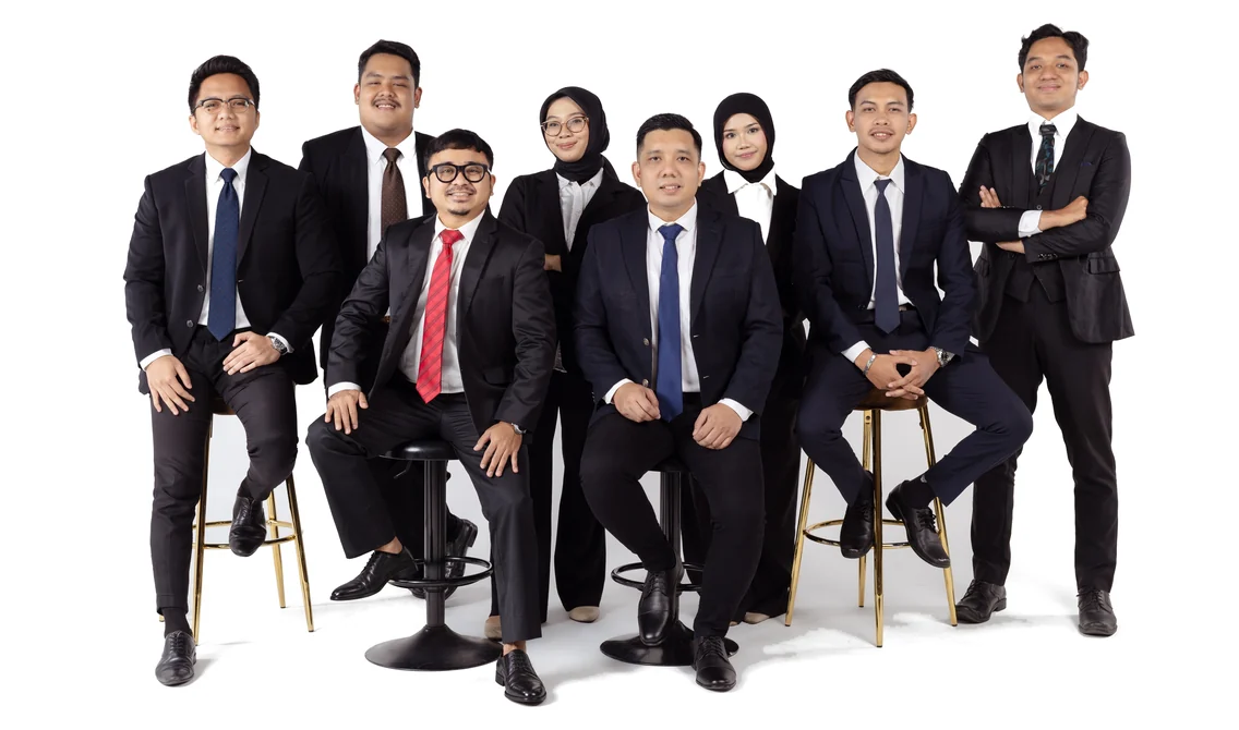 The eight lawyers of RAP and Co, seated and standing together